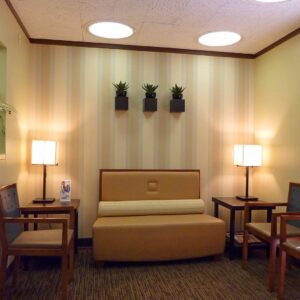 a reception area with wall art and striped wallpaper